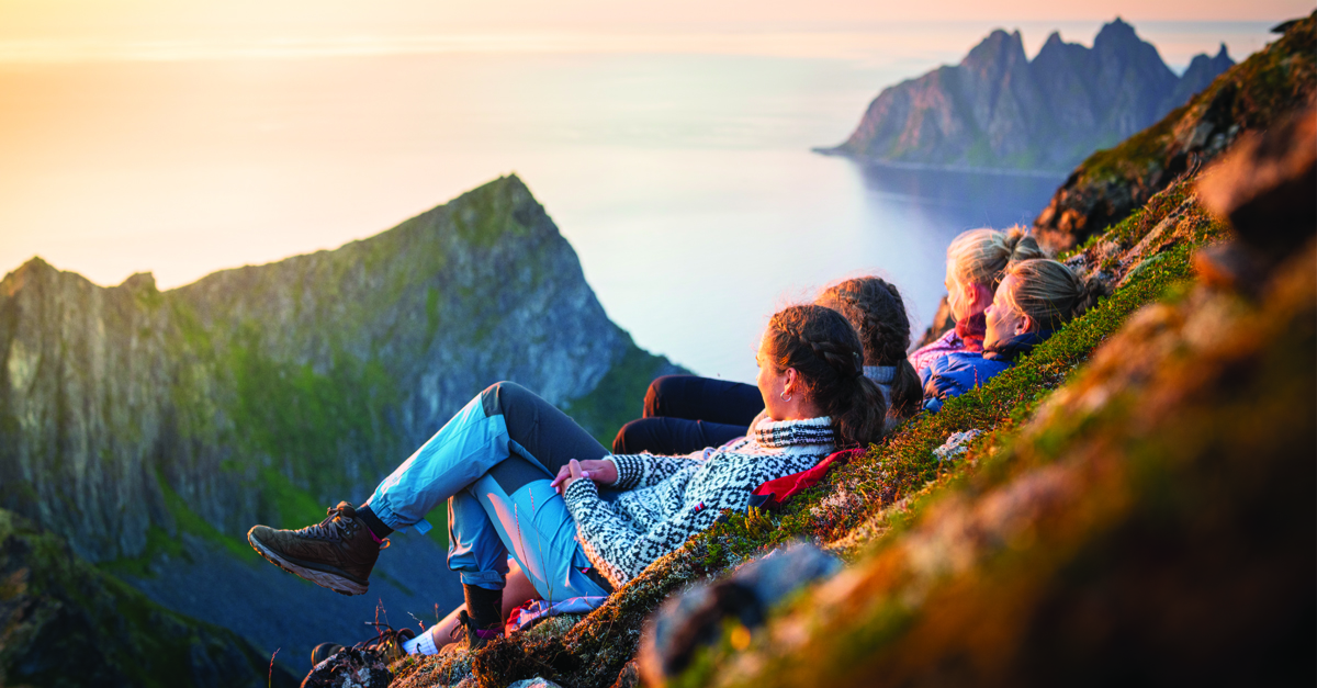 Cheerful young women watching sunset, Senja island, Norway