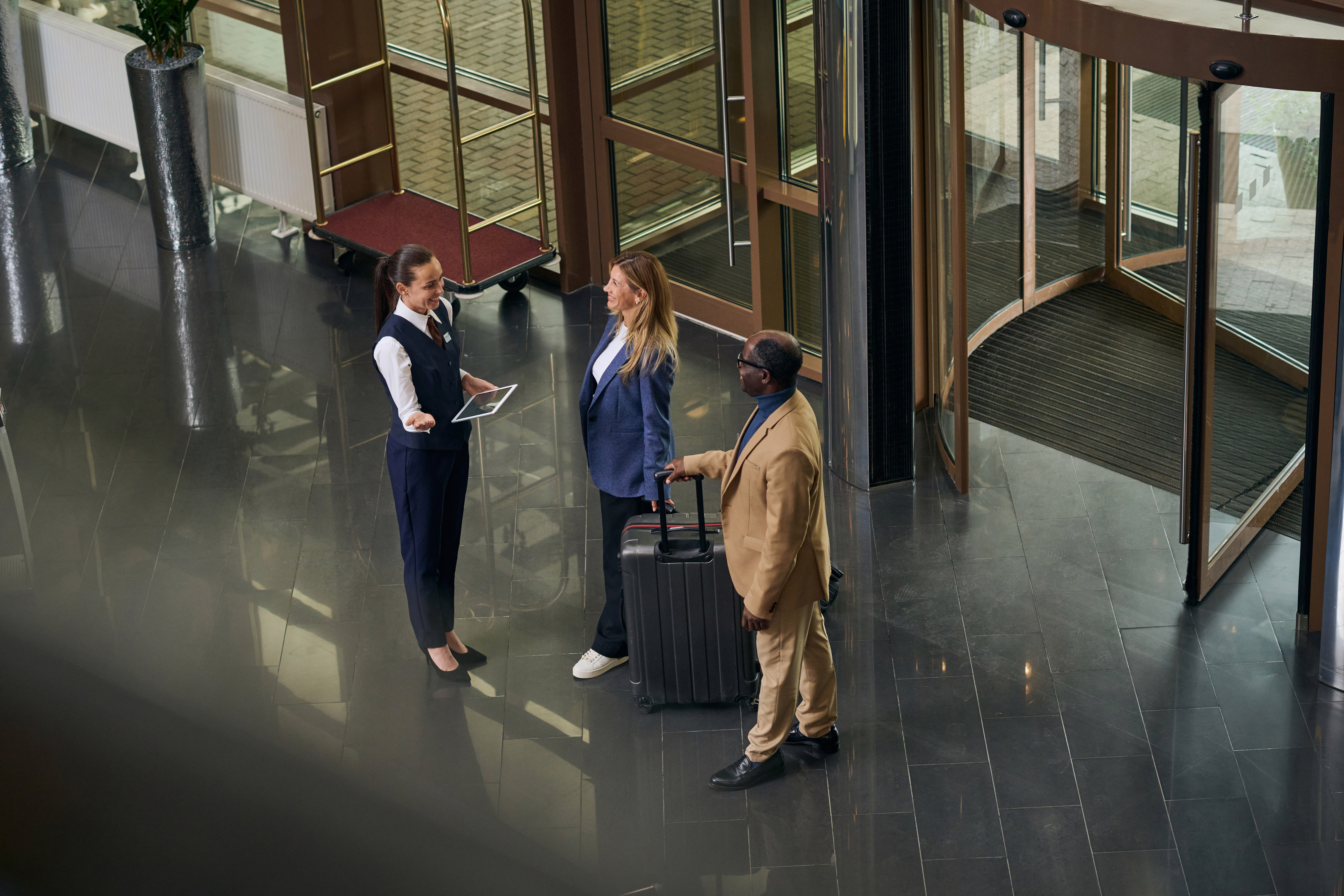 hotel manager greets guests in a hotel