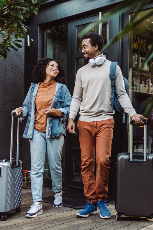 Young couple checking in off airport with ACUS Mobile.